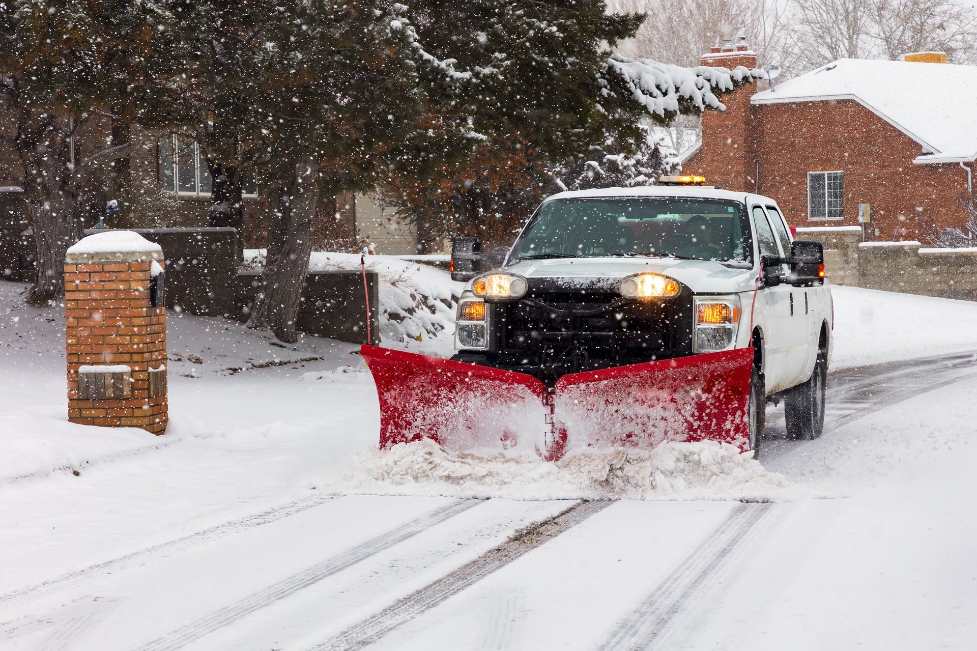 Snow plow clearing the neighborhood side roads